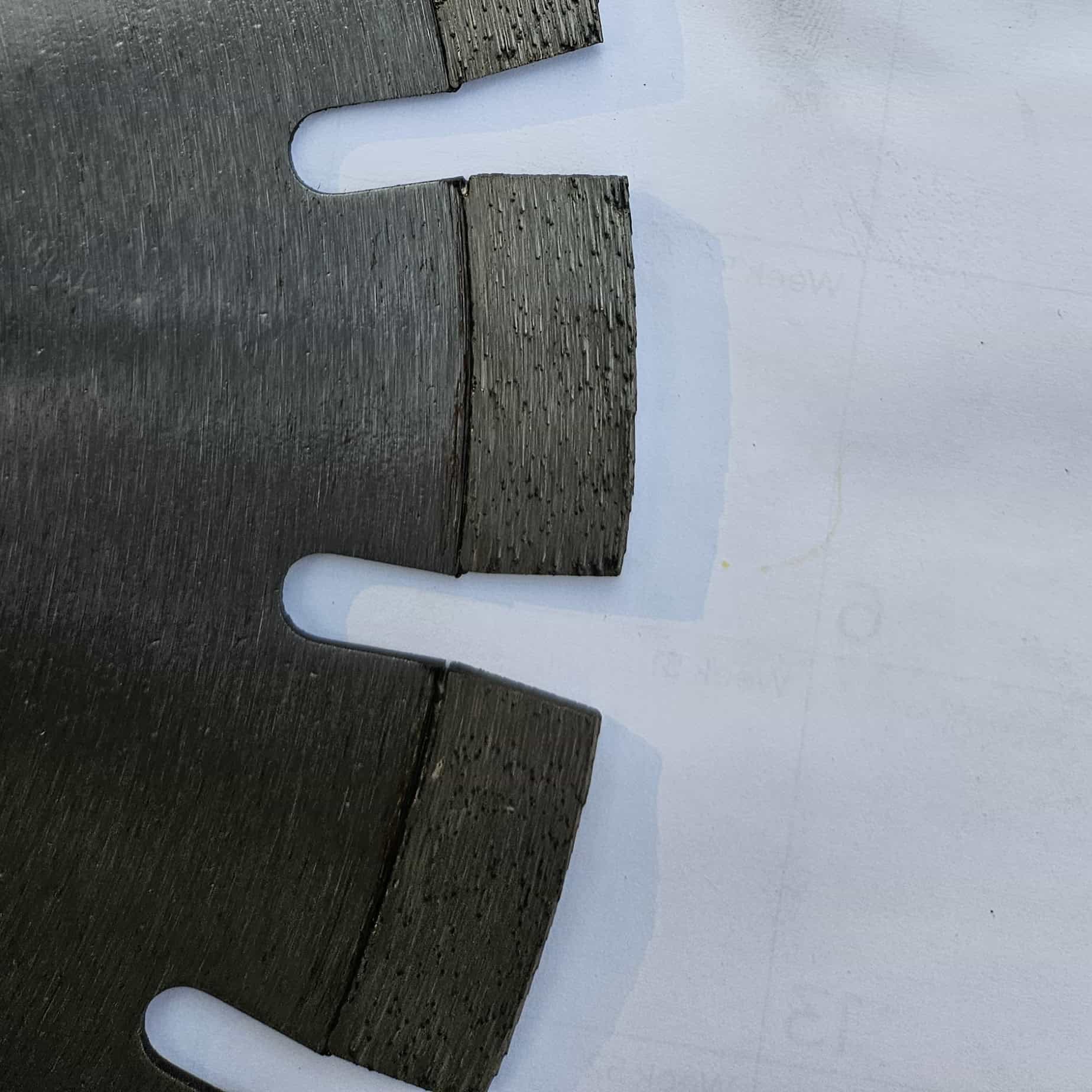 Close-up of deep draft diamond segments on VCT TH15ALW350 350mm laser welded blade showing stepped segment geometry for undercut protection on asphalt and abrasive materials