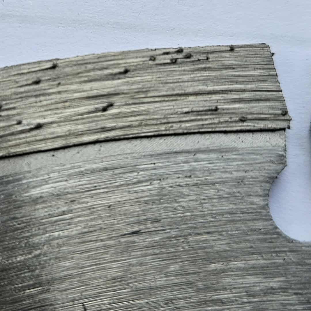 Close-up of VUS Cutting Technology C1 diamond blade showing silver brazed segment surface with embedded diamond particles and precision-ground cutting edge